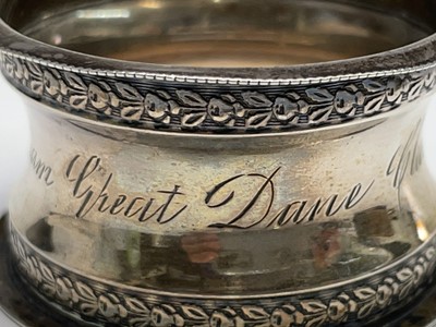 Lot 427 - Four unmatched engraved silver napkin rings,...