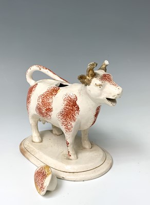 Lot 473 - A 19th century Staffordshire cow creamer,...