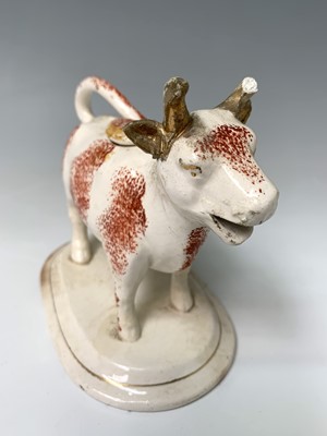 Lot 473 - A 19th century Staffordshire cow creamer,...