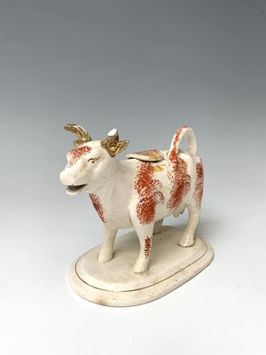 Lot 473 - A 19th century Staffordshire cow creamer,...