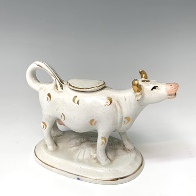 Lot 474 - A 19th century Staffordshire cow creamer,...