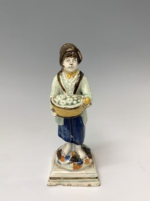 Lot 476 - A Prattware figure of a boy, late 18th century,...