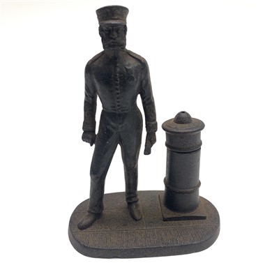 Lot 549 - A cast iron taper/ match stand with a military...