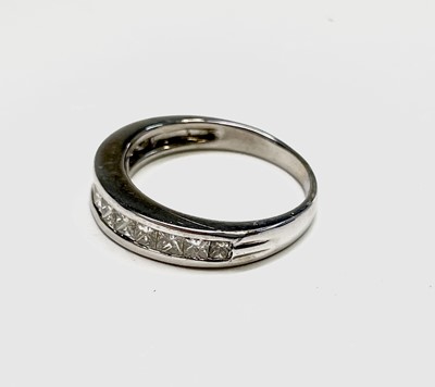 Lot 162 - An 18ct white gold ring with a line of twelve...