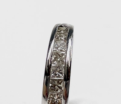 Lot 162 - An 18ct white gold ring with a line of twelve...