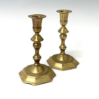 Lot 516 - A pair of 18th century brass candlesticks,...