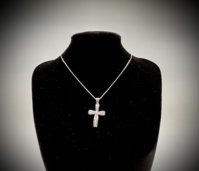 Lot 218 - An 18ct white gold cross pendant set with...