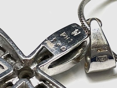 Lot 218 - An 18ct white gold cross pendant set with...