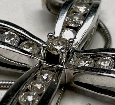Lot 218 - An 18ct white gold cross pendant set with...