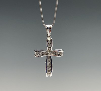 Lot 218 - An 18ct white gold cross pendant set with...
