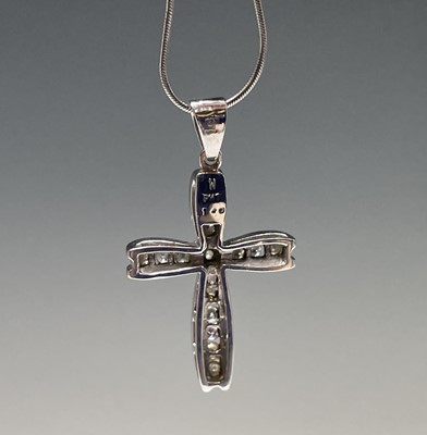 Lot 218 - An 18ct white gold cross pendant set with...