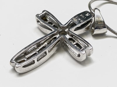 Lot 218 - An 18ct white gold cross pendant set with...