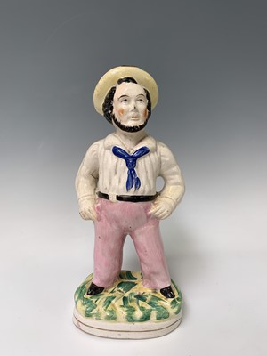 Lot 552 - A Victorian Staffordshire figure of a sailor,...