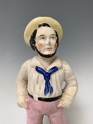 Lot 552 - A Victorian Staffordshire figure of a sailor,...