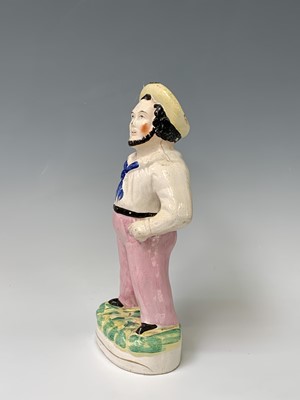 Lot 552 - A Victorian Staffordshire figure of a sailor,...
