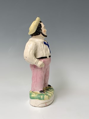 Lot 552 - A Victorian Staffordshire figure of a sailor,...