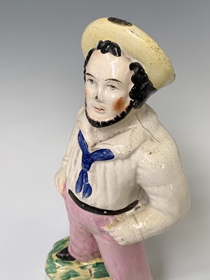 Lot 552 - A Victorian Staffordshire figure of a sailor,...