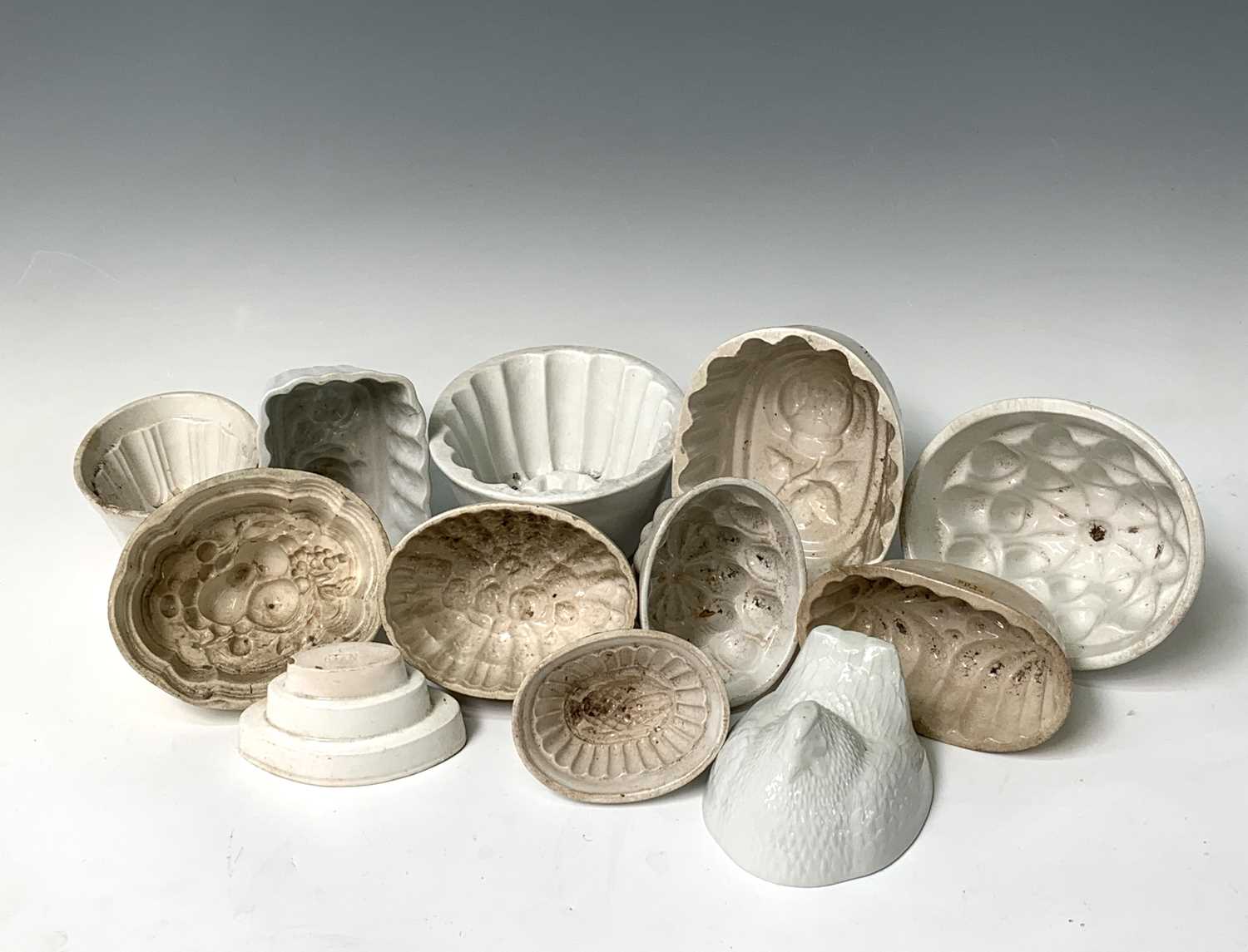 Lot 559 - Twelve various white ceramic jelly moulds....