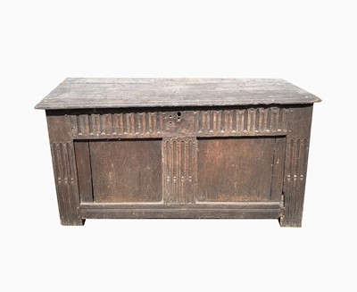 Lot 569 - A 17th century oak coffer, the lid in three...