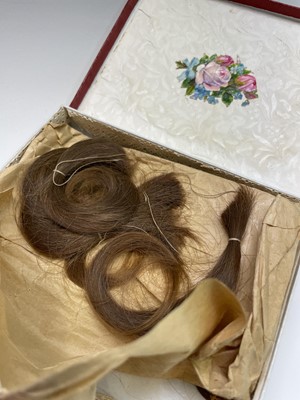 Lot 55 - A box containing a collection of locks of hair,...