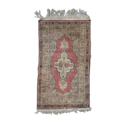 Lot 1256 - A Turkish art silk rug, circa 1930-1950, the...