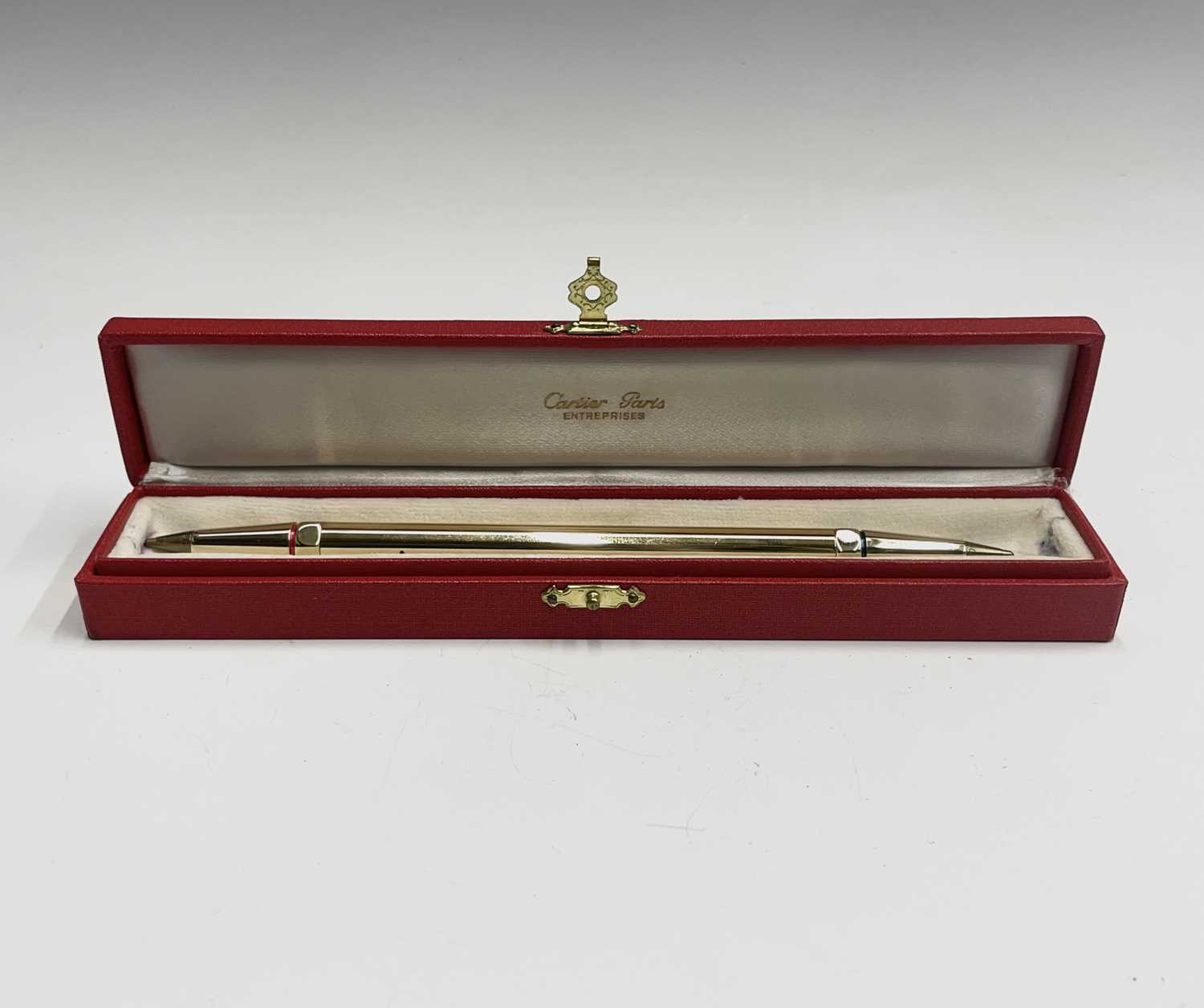 Lot 150 - A Cartier gold plated pen, one end with a red...