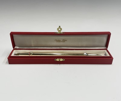 Lot 150 - A Cartier gold plated pen, one end with a red...