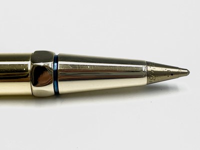 Lot 150 - A Cartier gold plated pen, one end with a red...