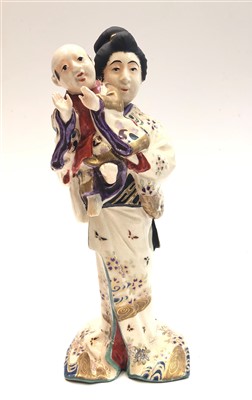 Lot 736 - A Japanese Satsuma figure of a mother and...