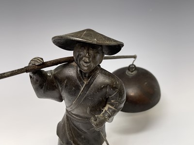 Lot 357 - A Japanese metal figure of a man, early 20th...