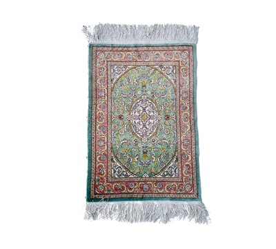 Lot 3202 - A Turkish silk rug, the pale blue field with...