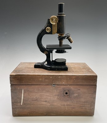 Lot 82 - A black lacquered and brass microscope, by...