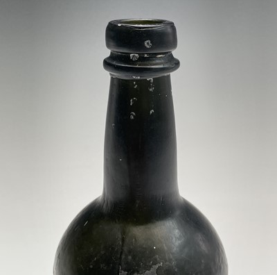 Lot 824 - A 19th century green glass bottle. Height 21cm