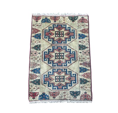 Lot 1228 - A Turkish rug, late 20th century, the ivory...