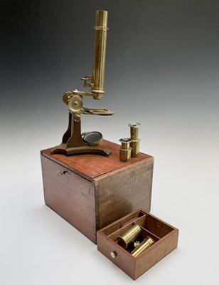 Lot 164 - A late Victorian brass microscope, with lenses,...