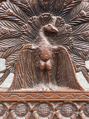 Lot 1001 - An Anglo-Indian carved teak open armchair,...