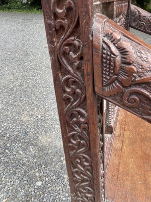 Lot 1001 - An Anglo-Indian carved teak open armchair,...