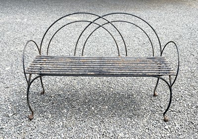 Lot 614 - A wrought and cast metal garden bench with...