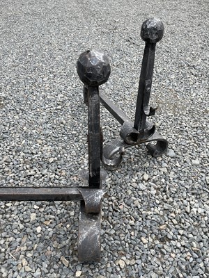 Lot 180 - A pair of wrought iron fire dogs, mid 20th...
