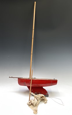 Lot 265 - A vintage red painted pond yacht of primitive...