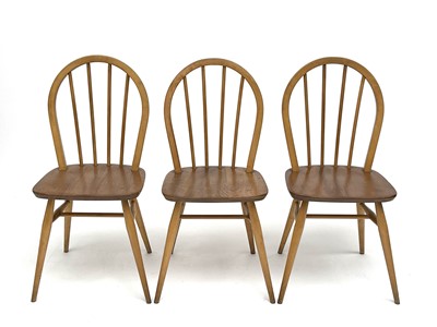 Lot 3056 - A set of three Ercol beech and light elm hoop...