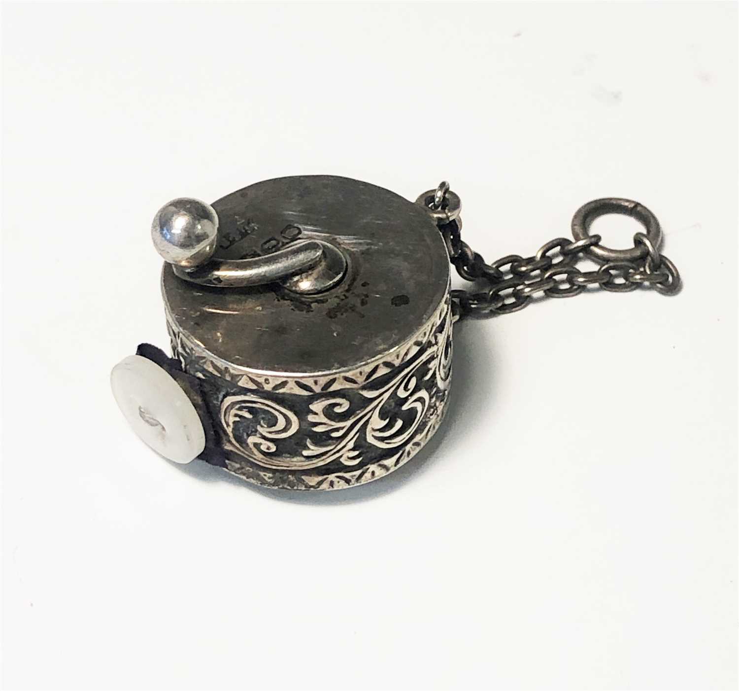 Lot 2013 - A silver cased tape measure
