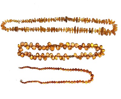 Lot 646 - Three "amber" necklaces 129gm