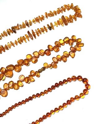 Lot 646 - Three "amber" necklaces 129gm