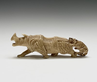 Lot 213 - A Japanese ivory carving of a rhinoceros and...