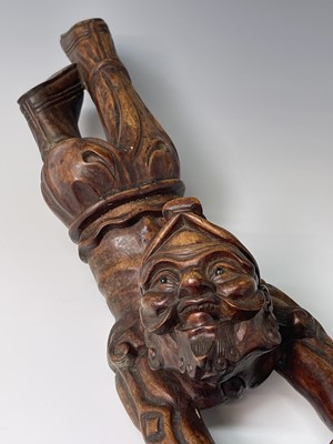 Lot 249 - A Chinese carved hardwood figure of man...