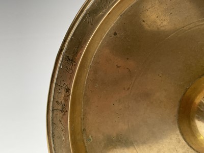 Lot 255 - A Chinese polished bronze dish, the rim with...