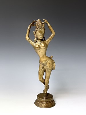 Lot 1046 - A Burmese tall brass figure of a dancer, 20th...