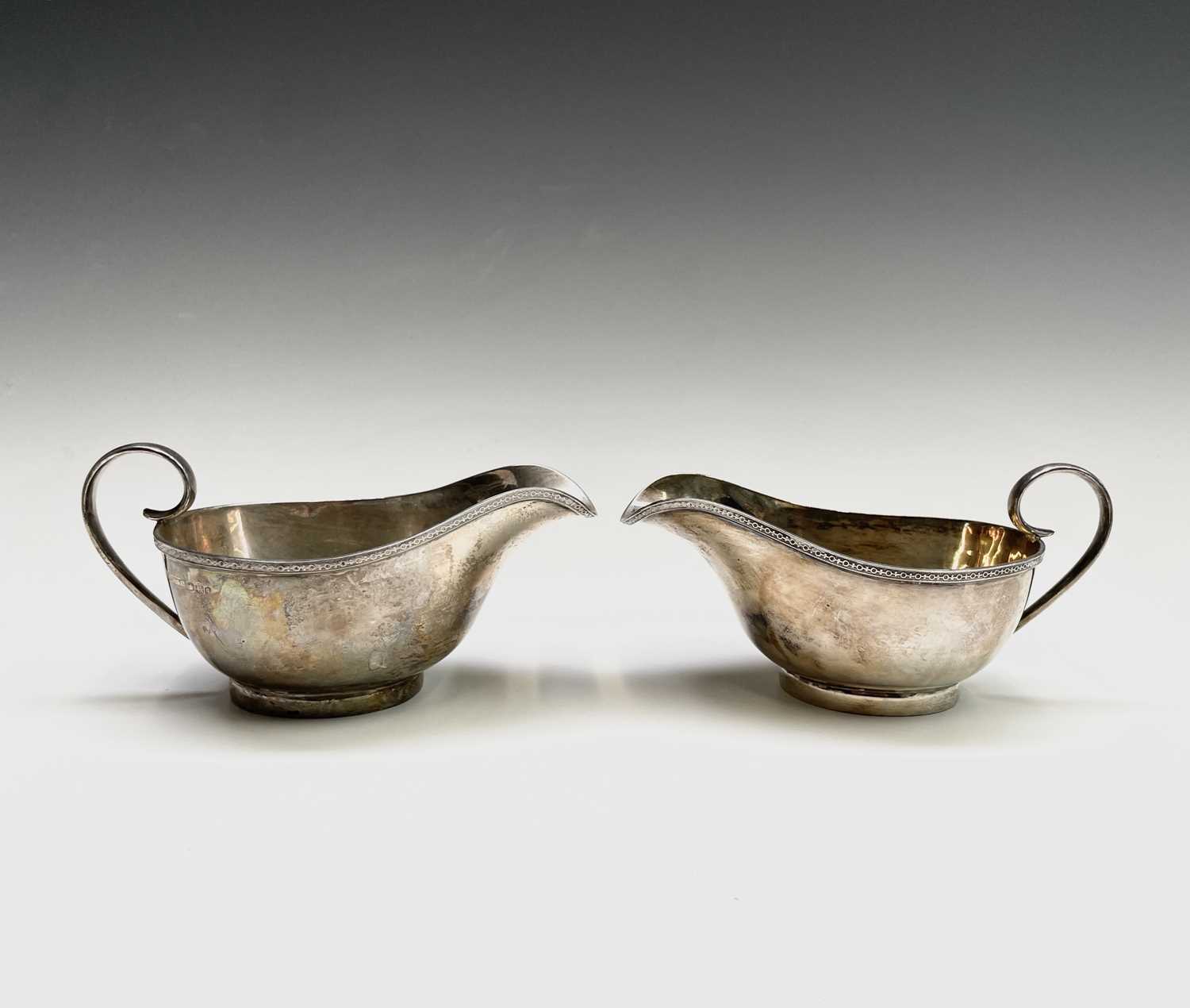 Lot 37 - A pair of George V silver sauce boats by...