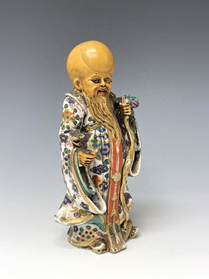 Lot 285 - A Chinese porcelain figure of an immortal,...